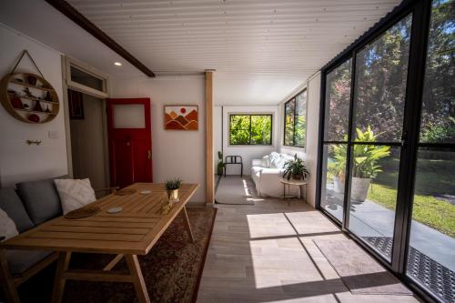 a living room with a table and a couch at Tranquil Rainforest Studio Kuranda in Kuranda