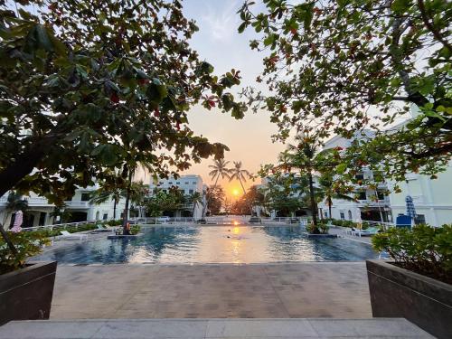 a pool in a building with the sunset in the background at Stella Marina Boutique Hotel in Phu Quoc
