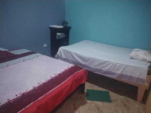a room with two beds and a dresser at Departamento Yaqui in Aguas Claras