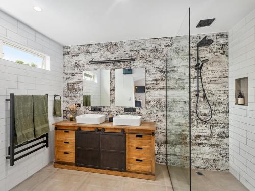 Country Idyll - Sandspit Holiday Cottage في Sandspit: حمام مع مغسلتين ودش