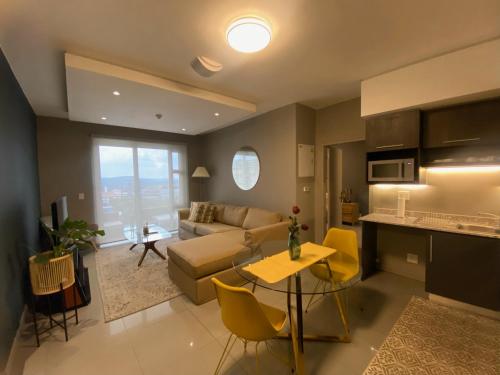 a living room with a couch and a table at Luxurious 2 Bed @ The Tyrwhitt in Johannesburg