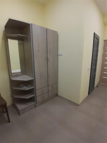 an empty room with a cabinet and a mirror at Spartak in Sisian