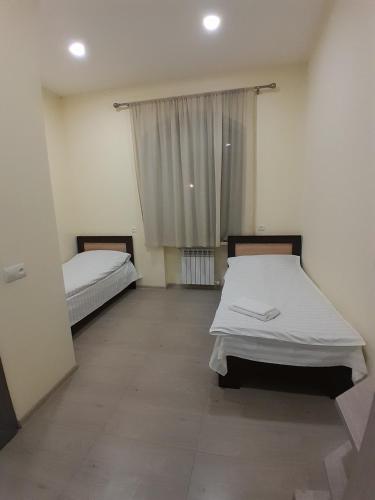 a bedroom with two beds and a window at Spartak in Sisian