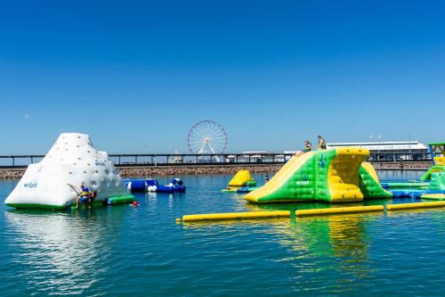 a group of inflatable slides in the water at Serenity Blue Waters - 3 bedrooms on 8th floor at Darwin Waterfront in Darwin