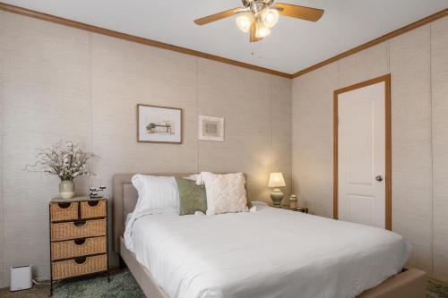 a bedroom with a white bed and a ceiling fan at Hill Country Memories in Kerrville
