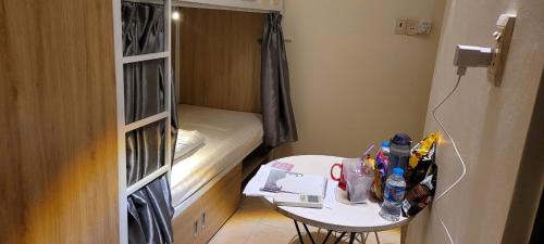a small room with a small table and a small bed at REDHOME DORM in Ho Chi Minh City