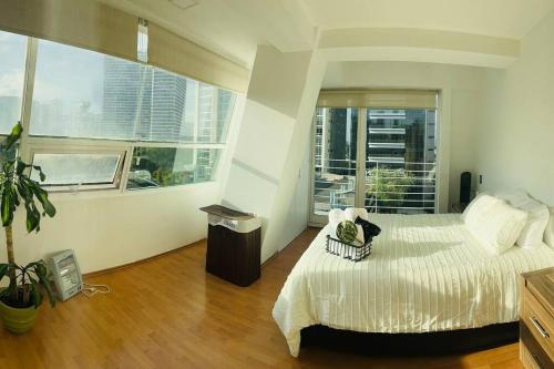 a bedroom with a bed and a large window at Polanco Pool Amazing view gym parking in Mexico City