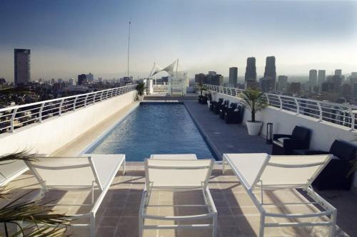 a swimming pool on the roof of a building at Polanco Pool Amazing view gym parking in Mexico City