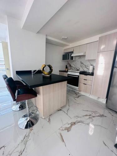 a kitchen with marble floors and a counter and chairs at Polanco Pool Amazing view gym parking in Mexico City