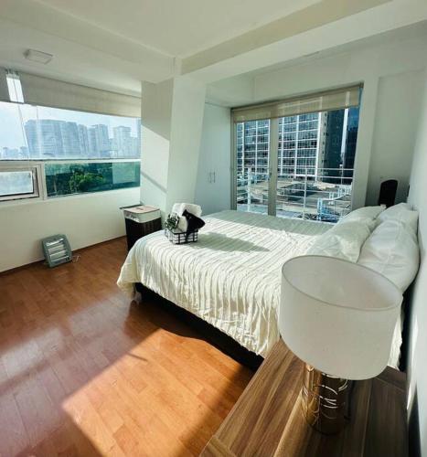 a bedroom with a large bed and a large window at Polanco Pool Amazing view gym parking in Mexico City