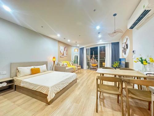 a bedroom with a bed and a dining room at Căn hộ hạng sang có bếp và ban công The Song Vung Tau - Luxury Homestay in Vung Tau