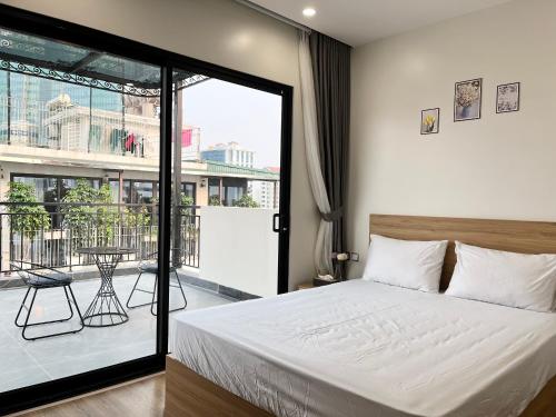 a bedroom with a bed and a balcony at 22Housing Luxury Apartment 81 Linh Lang in Hanoi