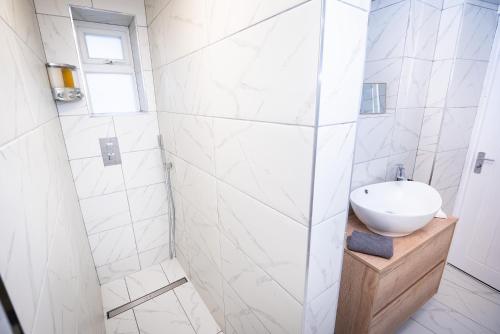 a white bathroom with a sink and a shower at Kings Arms Suites - Luxury Double - Waterfall Shower - Self Check In in Whitehaven