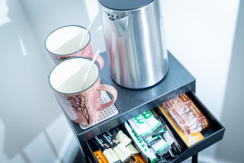 a shelf with two cups and a metal appliance at Kings Arms Suites - Luxury Double - Waterfall Shower - Self Check In in Whitehaven