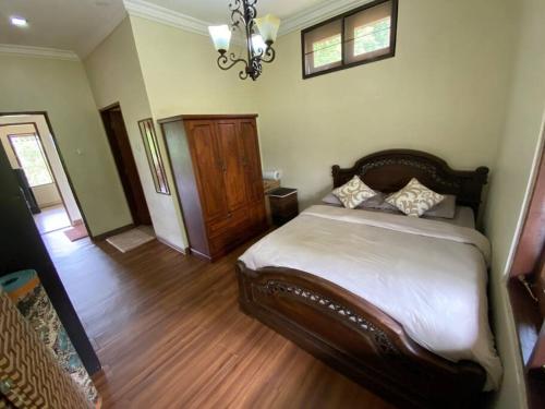 a bedroom with a bed and a chandelier at Hulu Tamu Off Grid Morrocan styled Hill Top Villa in Kampong Sungai Tamu