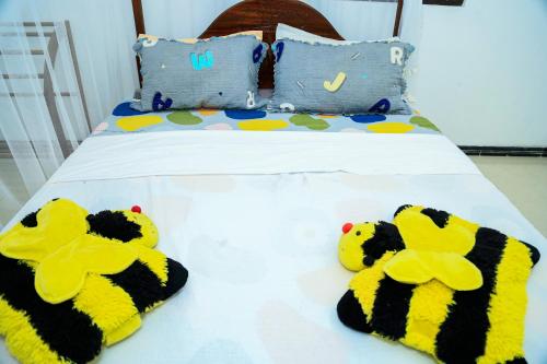 two stuffed animals are sitting on a bed at Eton Villa Talpe in Talpe