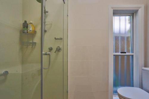 a bathroom with a glass shower with a toilet at 2 Bedroom House Situated at the Centre of Surry Hills 2 E-Bikes Included in Sydney