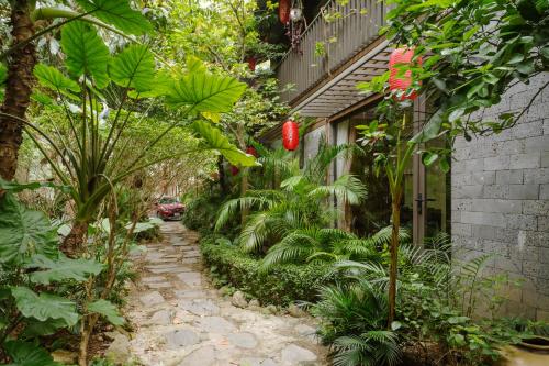 a garden path with plants and a building at King Kong Homestay in Ninh Binh