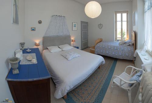 a bedroom with a large bed and a blue table at Château Robert in Raon-lʼÉtape