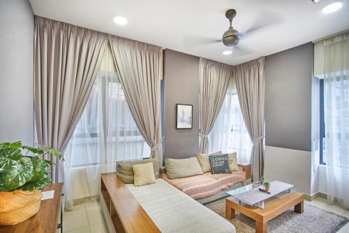 a living room with a couch and a table at Arte Plus KLCC Designer Suites by Cobnb in Kuala Lumpur