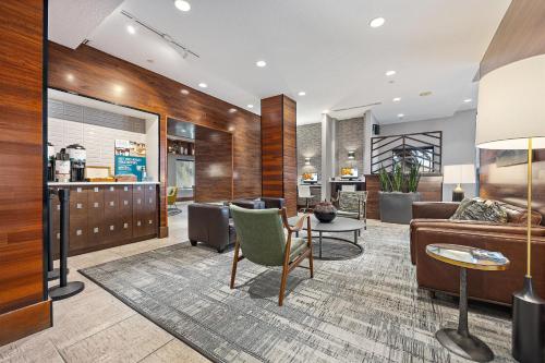 a living room with a couch and a table at Four Points by Sheraton Jacksonville Baymeadows in Jacksonville