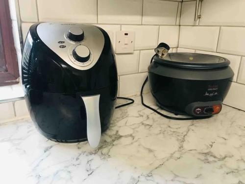 a toaster and a slow cooker sitting on a counter at Newtons Lodge in Nottingham