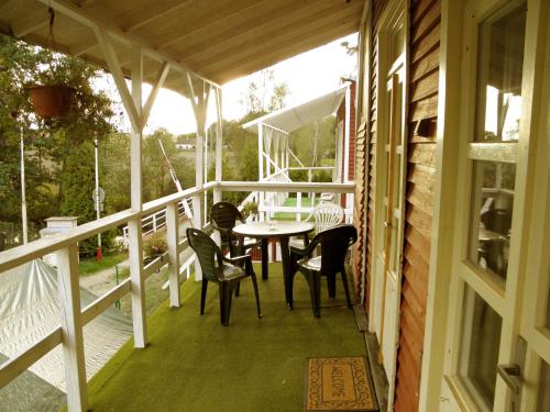 a porch with a table and chairs on it at Kempink U Šerifa in Protivín