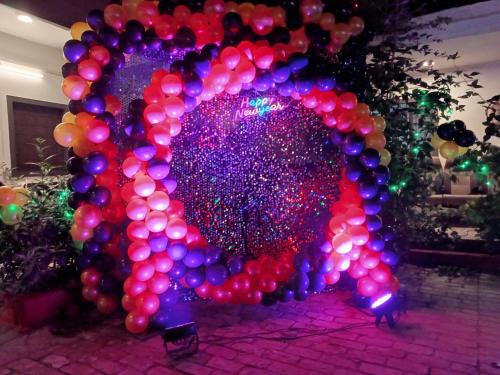 a large balloon arch with a bunch of balloons at HOTEL SHYAM PALACE INDIA AGRA in Agra