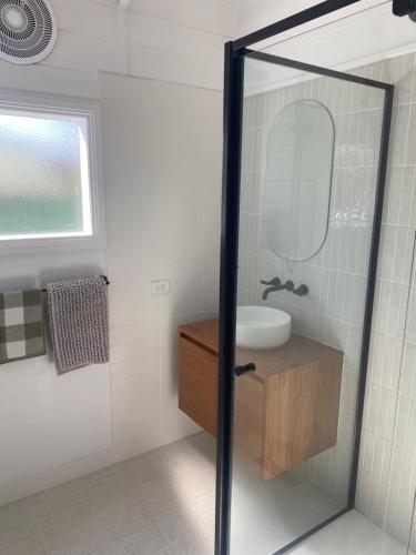 a bathroom with a sink and a mirror at Freshly renovated gem - 1.5km from the city centre in Quarry Hill