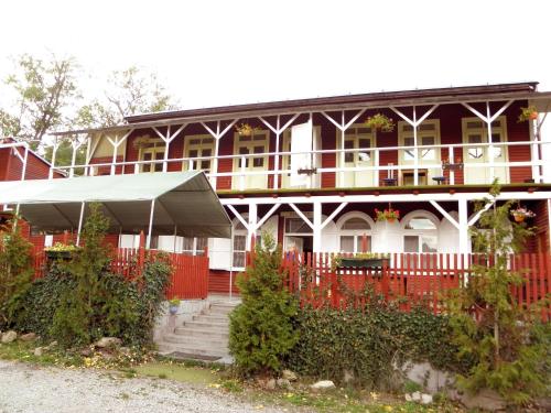 a large red and white house with a red fence at Kempink U Šerifa in Protivín