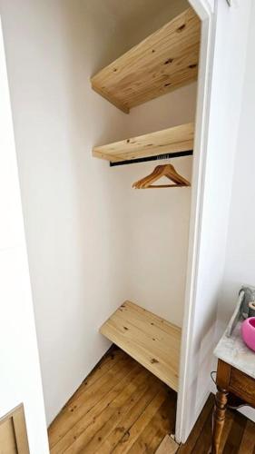 a closet with wooden shelves in a room at Lilas Rose in Thonon-les-Bains