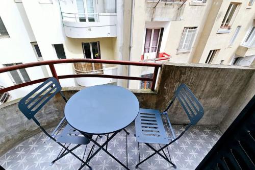 a blue table and two chairs on a balcony at Lilas Rose in Thonon-les-Bains