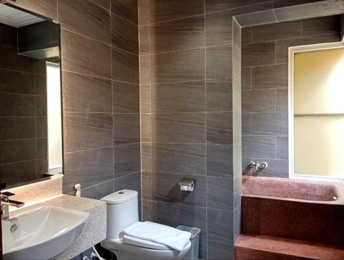 a bathroom with a toilet and a sink at Sokchea Kampot Hotel in Kampot