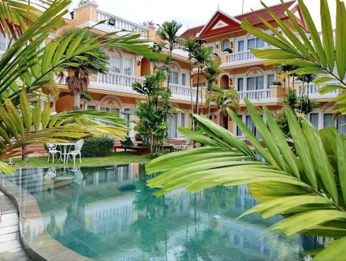 a hotel with a pool in front of a building at Sokchea Kampot Hotel in Kampot