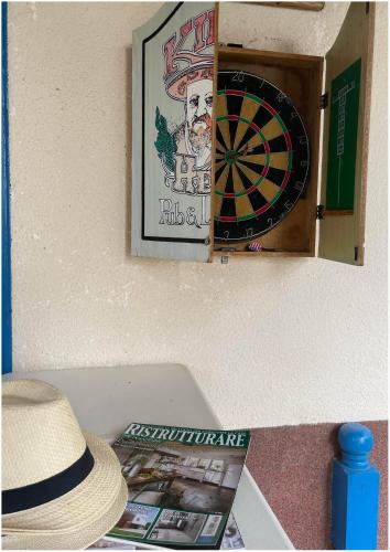 a picture of a dartboard on a wall with a hat at Villa Lakeview Paradise in Peštani