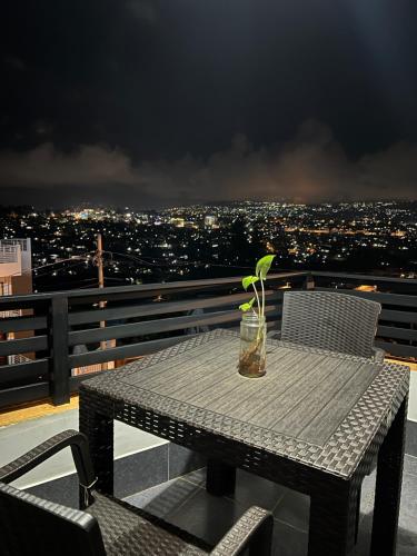 a table with a plant sitting on top of a balcony at CosyNook in Kigali