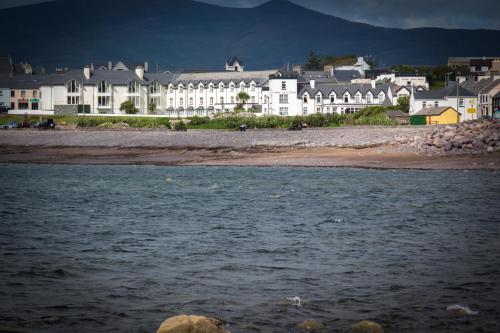 a view of a river with buildings in the background at Butler Arms Hotel in Waterville