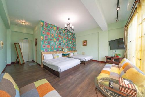 a living room with two beds and a tv at Sunny Homestay in Jian