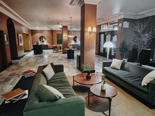 a large living room with couches and tables at FOUND Hotel Carlton, Nob Hill in San Francisco