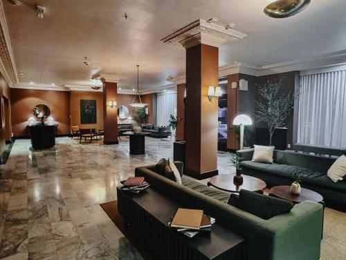 a large living room with couches and a table at FOUND Hotel Carlton, Nob Hill in San Francisco