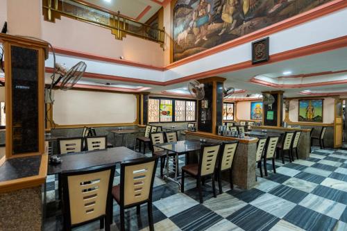 a dining room with tables and chairs in a restaurant at Sree Bharani Hotels in Tirunelveli