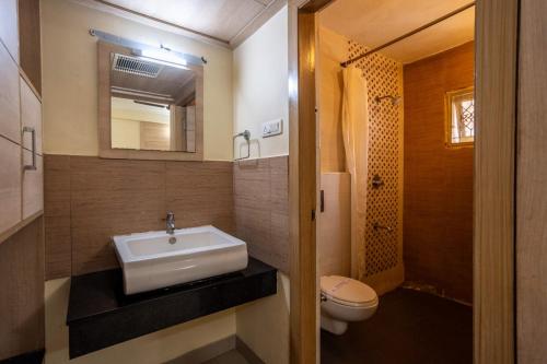 a bathroom with a sink and a toilet at Sree Bharani Hotels in Tirunelveli