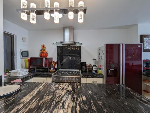 a kitchen with a stove and a refrigerator at Villa Aurora Beautiful Beachfront Apartment in Cancún