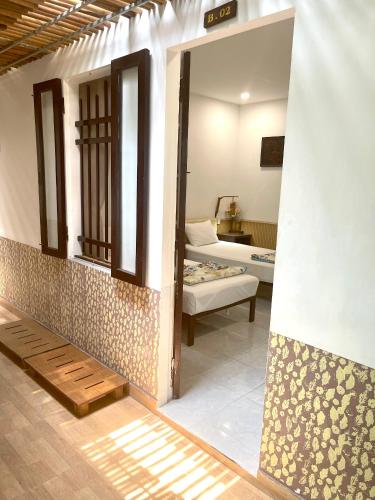 a room with a room with a bed and a couch at Homestay MINH TÚ in Hue