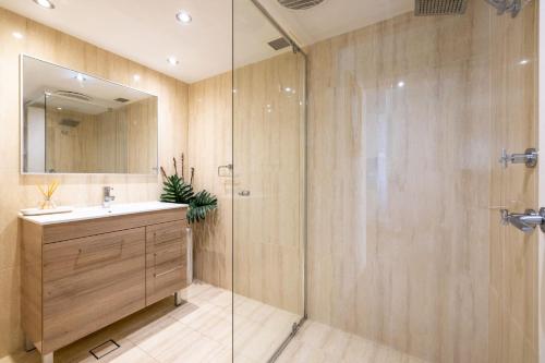a bathroom with a shower and a sink and a mirror at Fleetwood 3 63 Shoal Bay Road Relaxed living with water views overlooking Shoal Bay in Shoal Bay