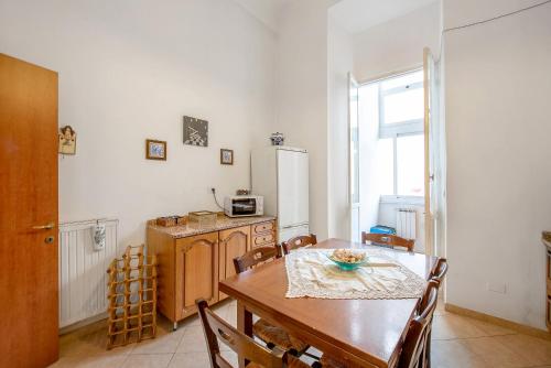 a kitchen with a wooden table and a dining room at Casa Olimpia in Savona