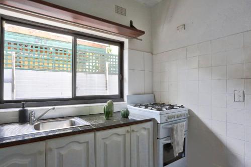 a kitchen with a stove and a sink and a window at Affordable 2 Bedroom House Surry Hills 2 E-Bikes Included in Sydney