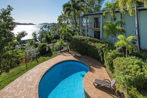 an image of a swimming pool in front of a house at Haven on Hamilton Island -private apartment with views & buggy Fully Renovated in 2023 in Hamilton Island