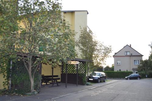 a parking lot with a bench and a building at Hotel Wolf in Prague