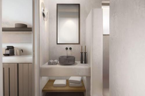 a bathroom with a sink and a mirror at Seascape, apartment with sea view 2 in Áno Meriá